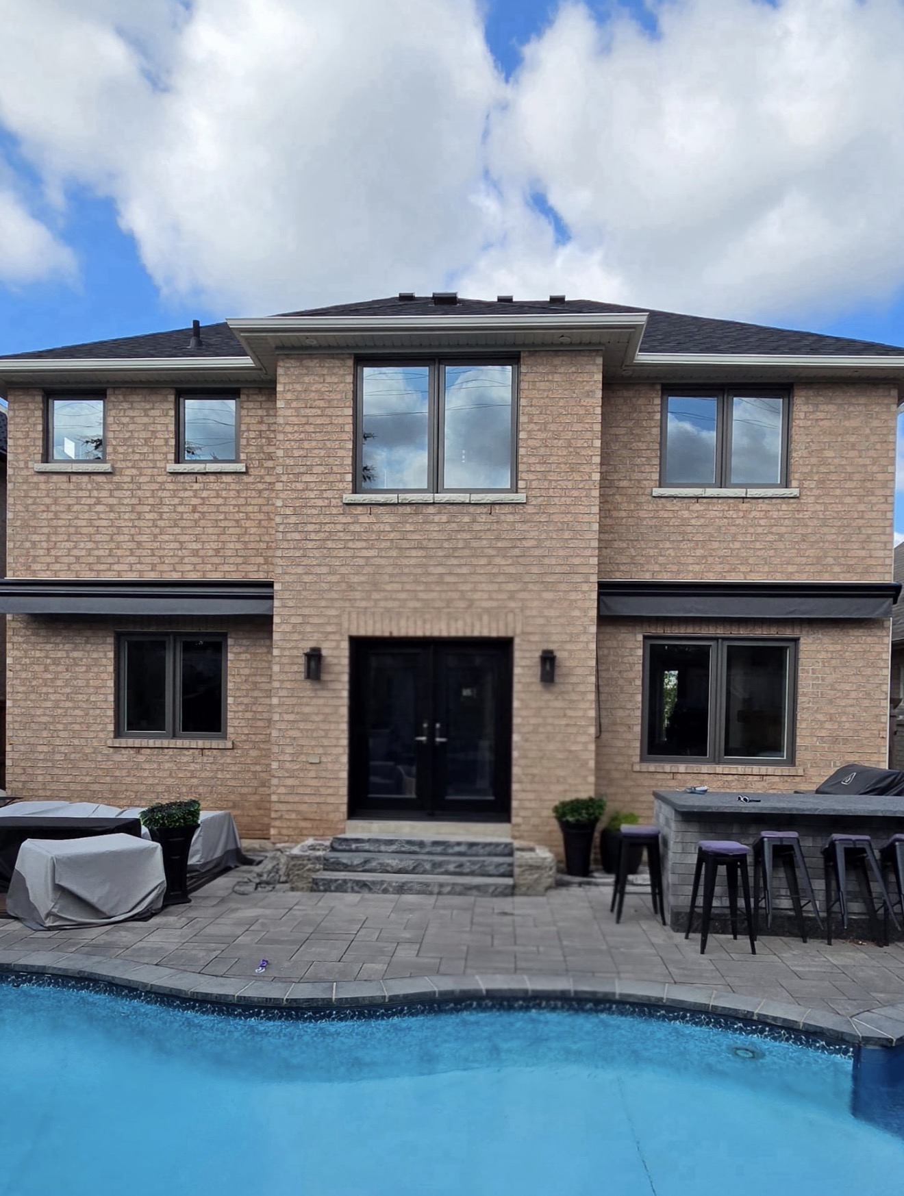 Black French patio doors opening to poolside