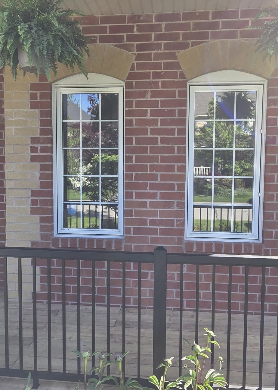 Covered porch arch-top casement windows before the black-frame conversion