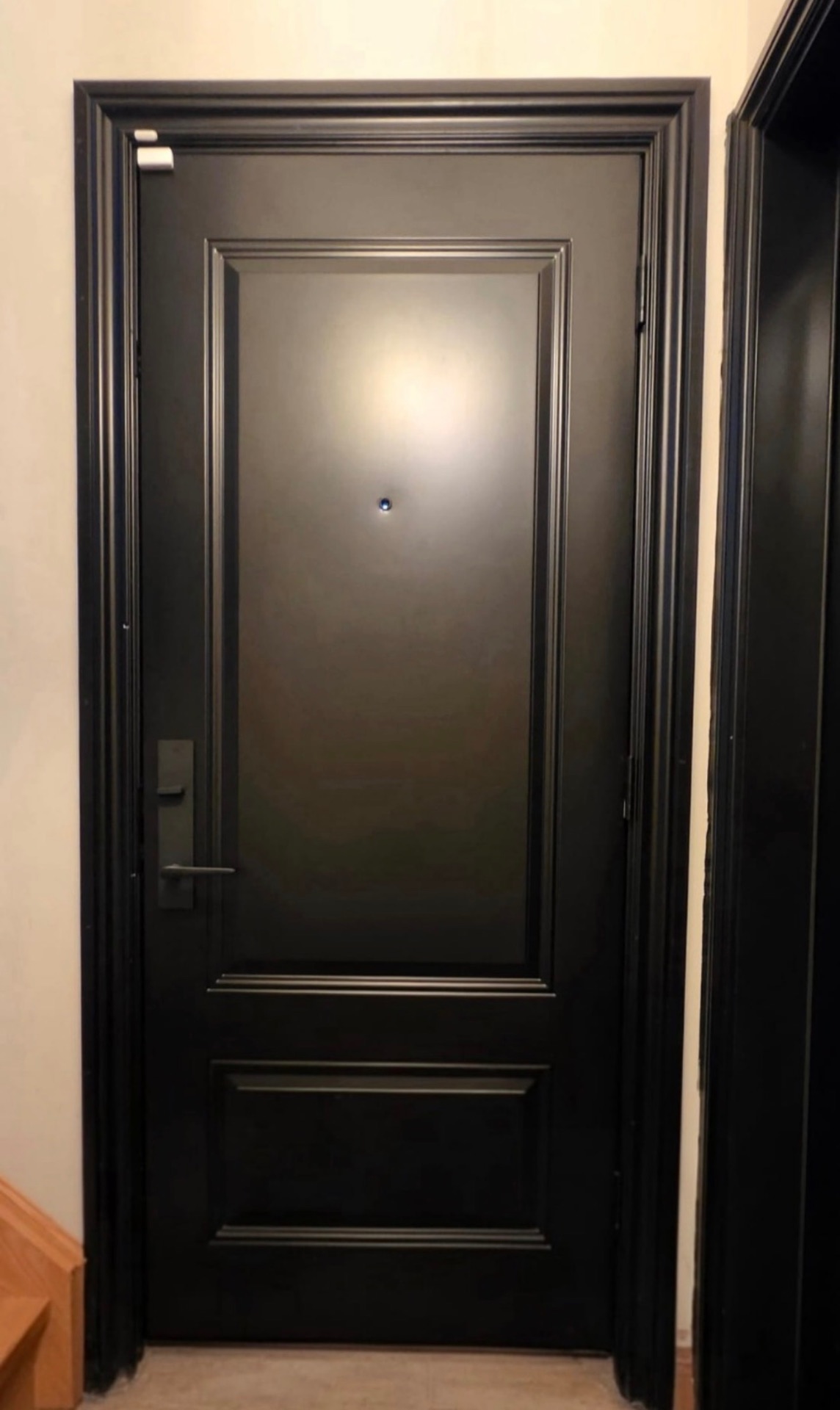 Interior side of a black steel entry door