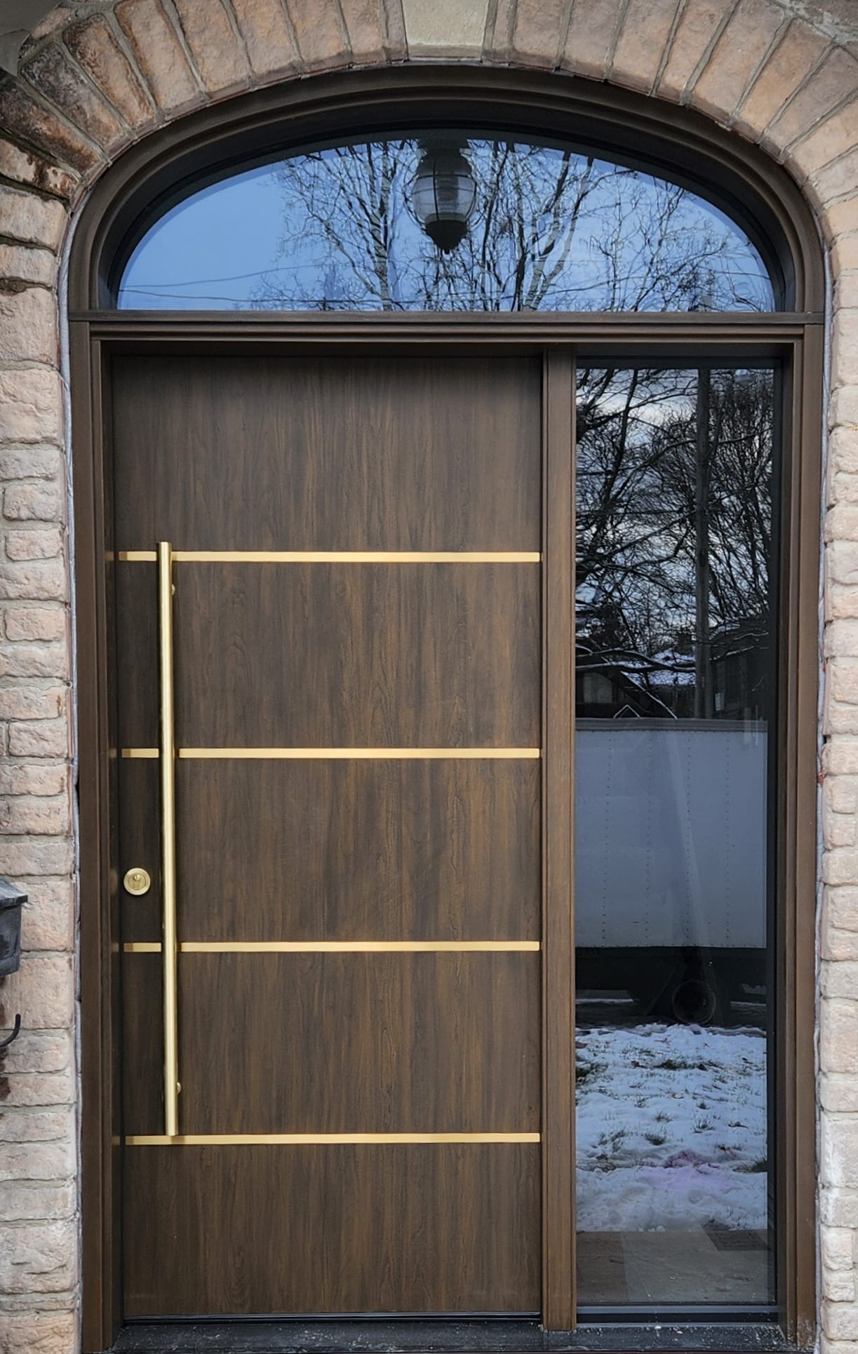 Walnut modern entry with gold inlays, sidelite and arched transom