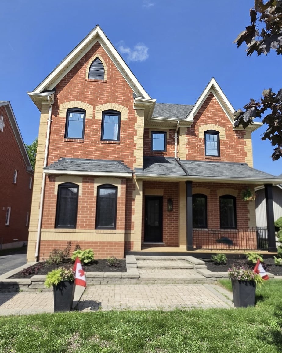Finished front elevation with black arch-top windows and black entry door