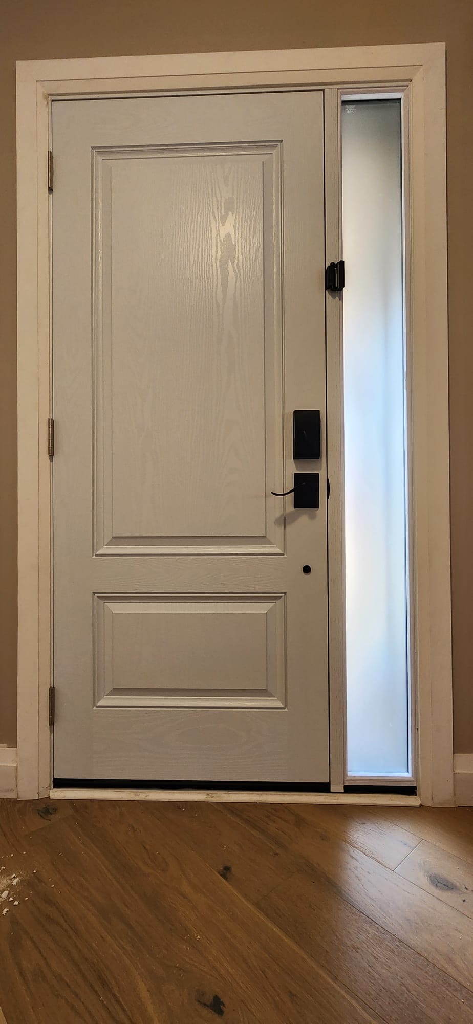 White two-panel fiberglass entry door with frosted sidelite