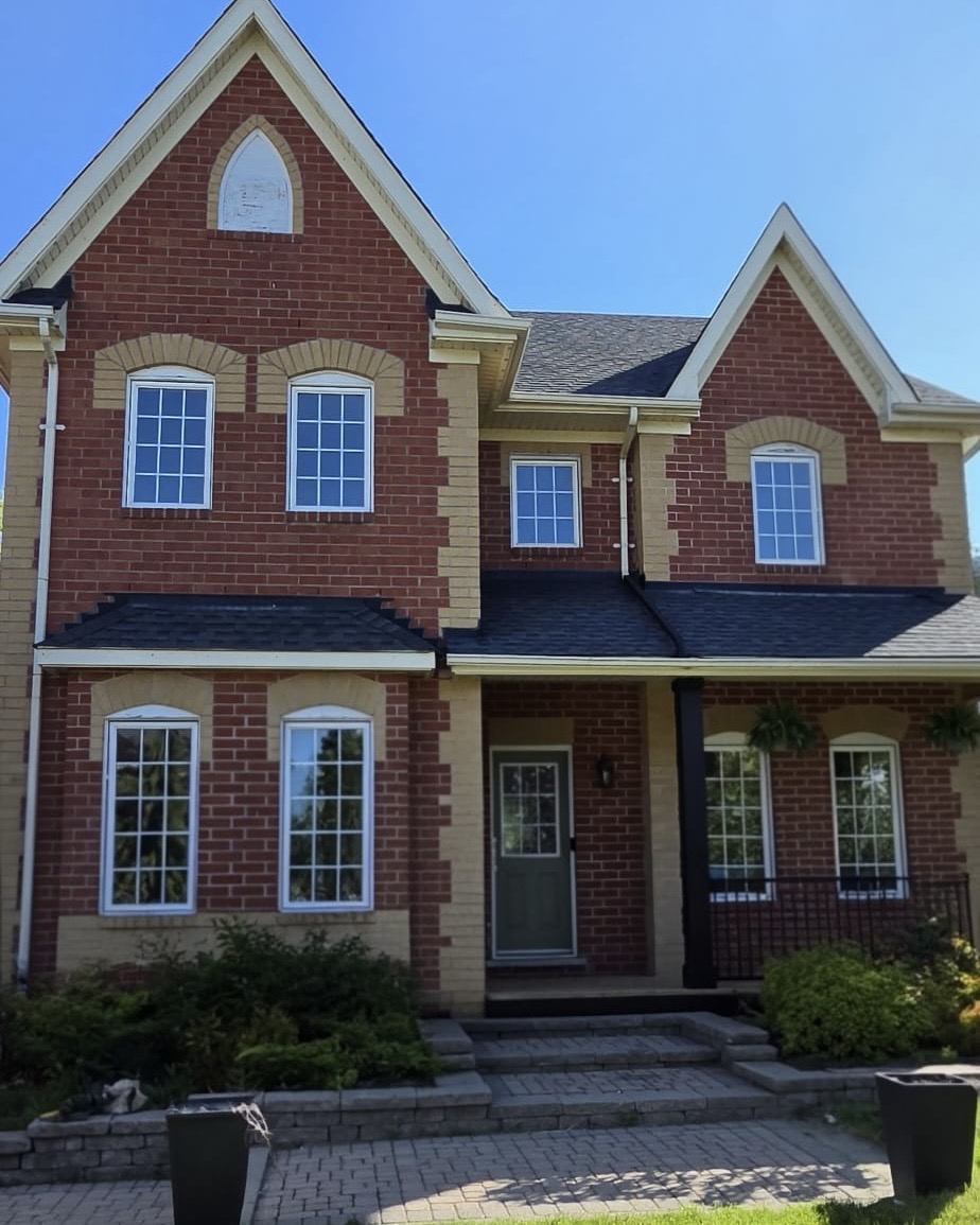 Original front elevation with white grilled windows before the black-frame conversion
