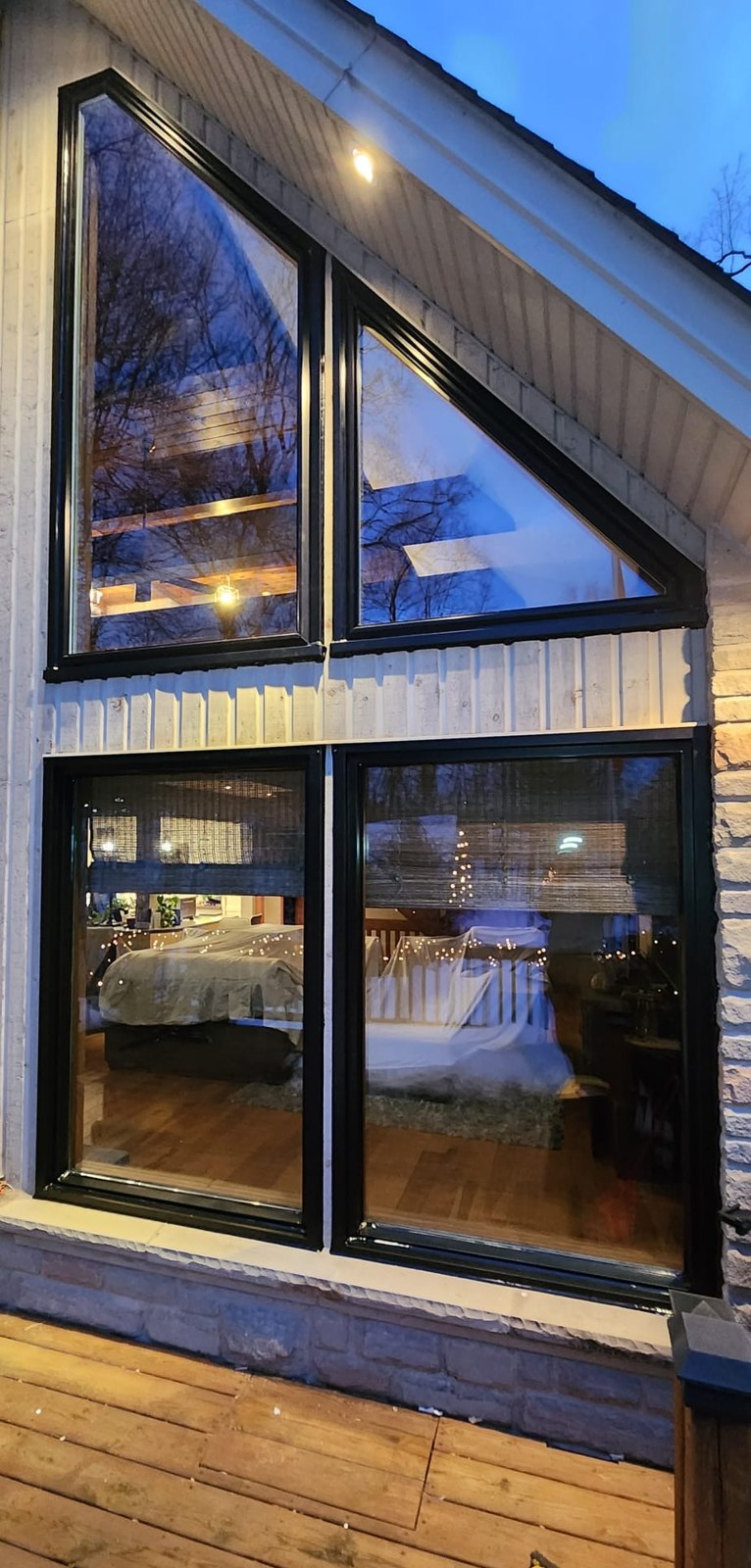 Angled triangular gable windows in black on a modern chalet
