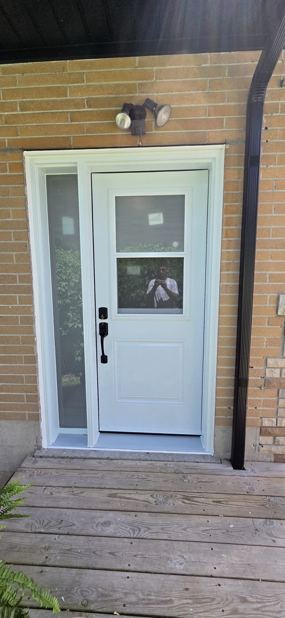 White entry door with two-lite glass and slim privacy sidelite
