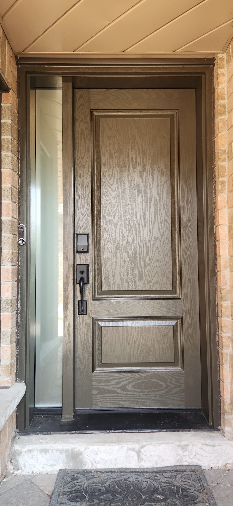 Bronze two-panel fiberglass entry with frosted privacy sidelite