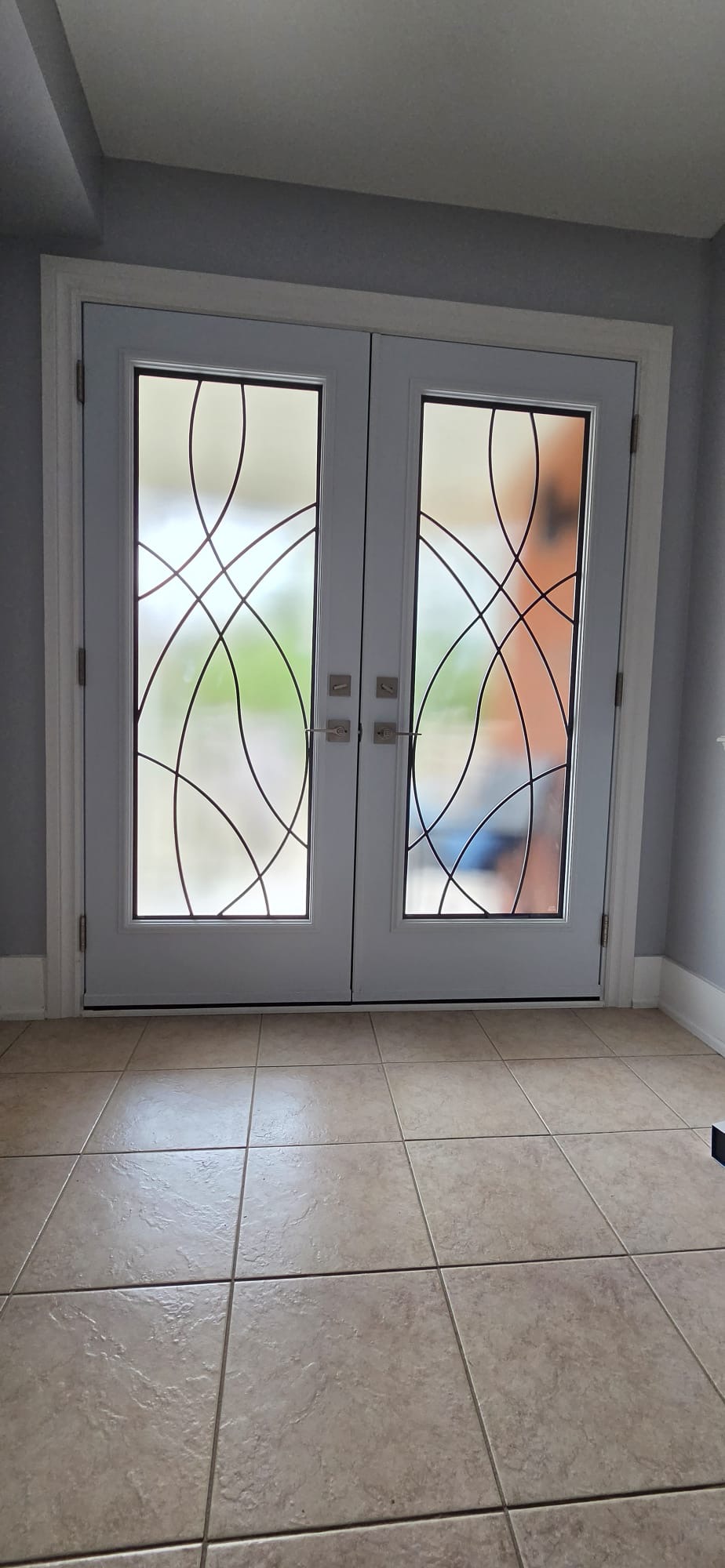White interior French doors with decorative wrought-iron glass inserts