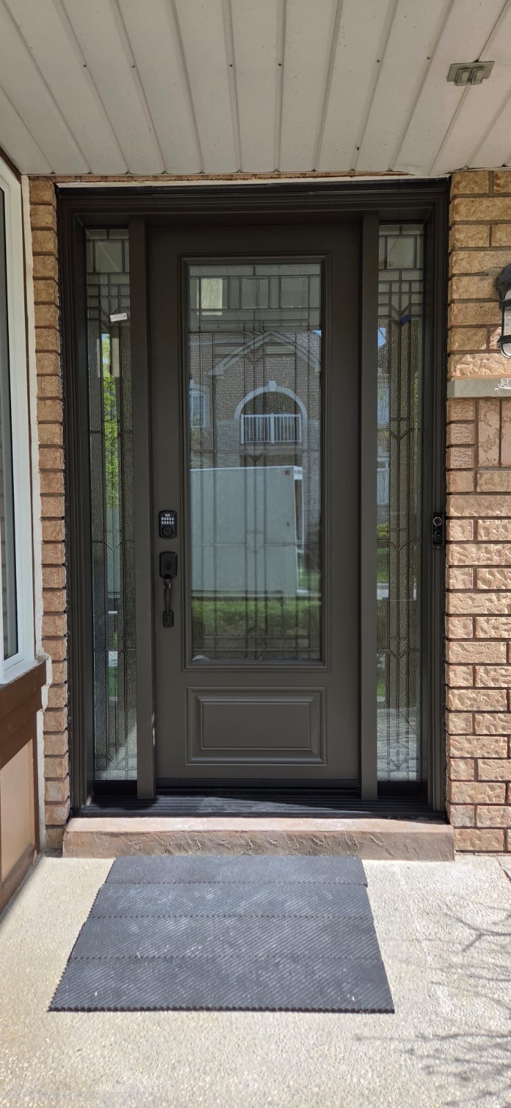 Bronze steel entry with decorative glass insert and privacy sidelites