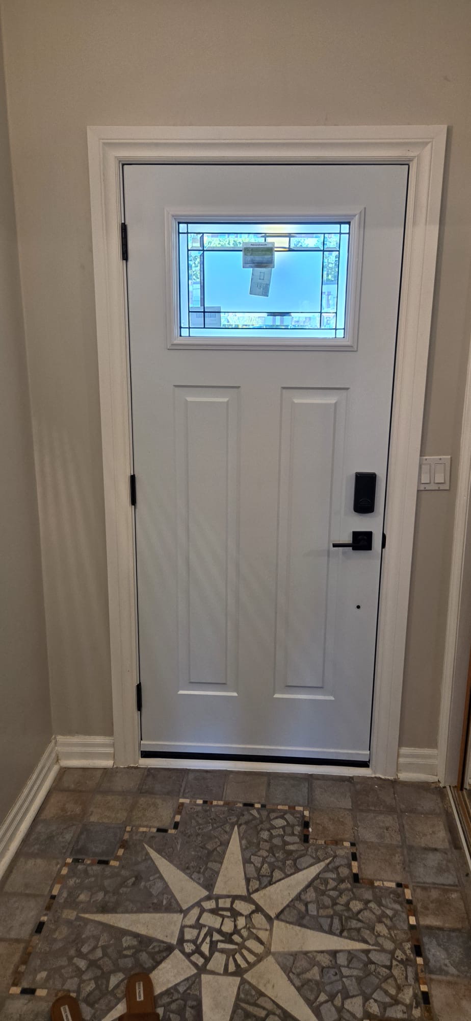 White craftsman entry door with stained-glass transom lite