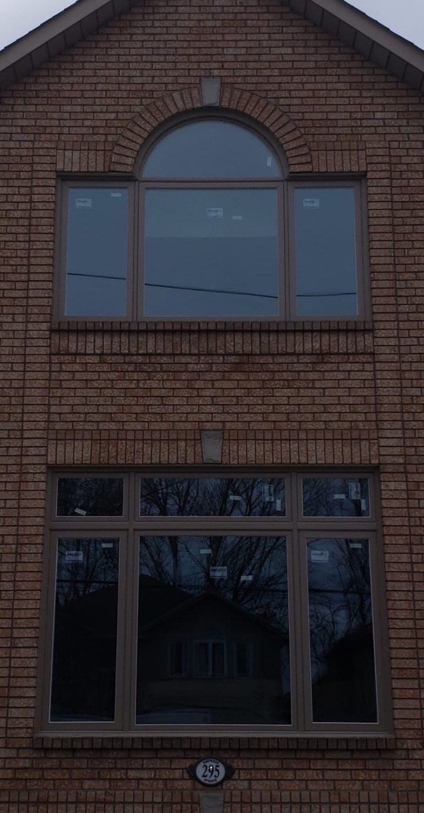 Beige-frame arch-top window and matching transom window package