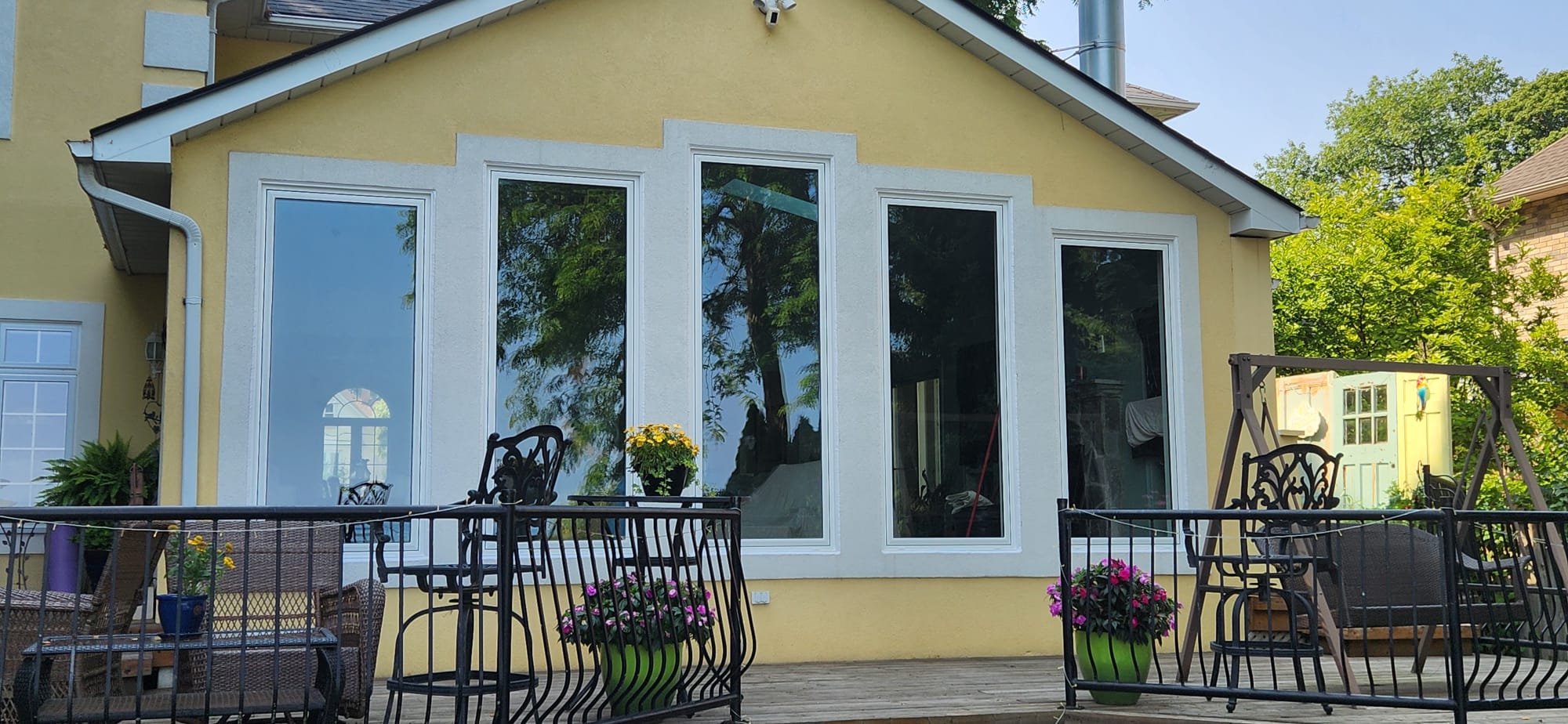 Gable-end picture window composition with tall fixed panes and transoms