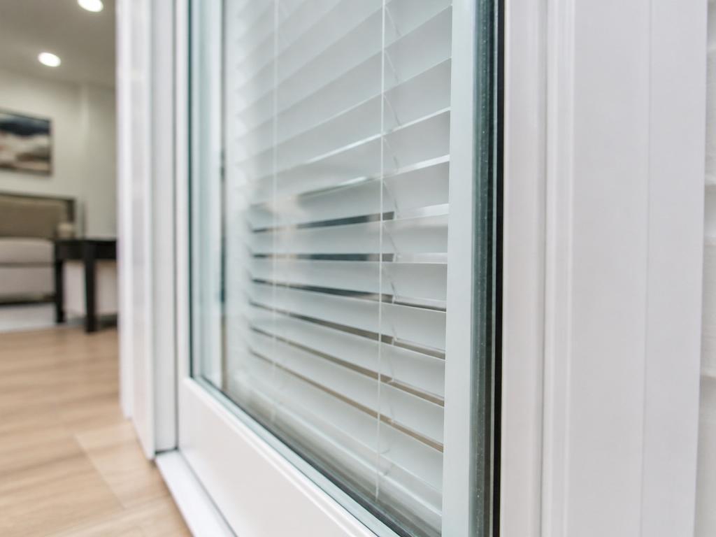 Internal mini-blinds sealed between the glass panes of a sliding patio door